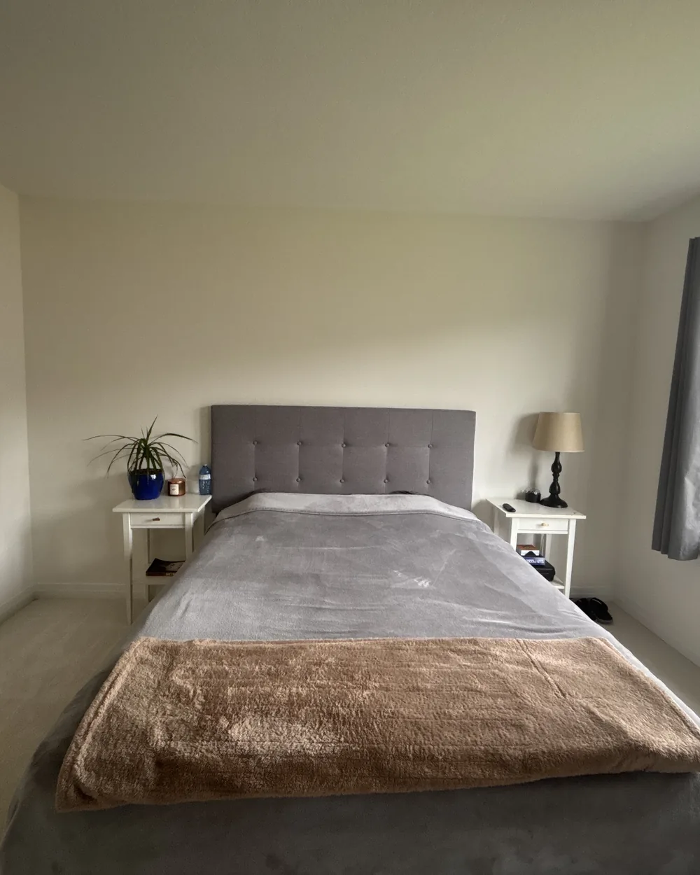 The same bedroom with the bed neatly made