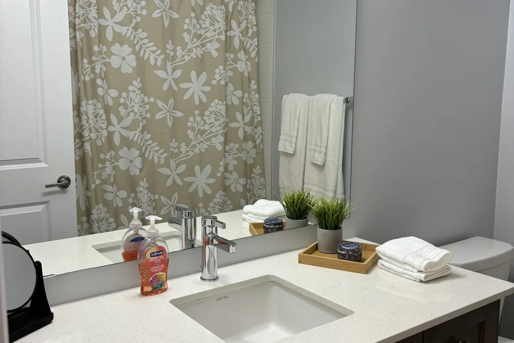 A clean bathroom vanity with folded towels